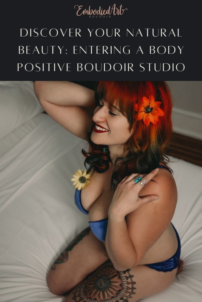 Blog Post: Discover Your Natural Beauty: Entering a Body Positive Boudoir Studio.  Image of colorful-haired woman covered in tattoos and flowers smiling happily on the bed. Photo by Embodied Art Boudoir. Denver boudoir photographer, colorado boudoir photographer, Boudoir photoshoot, boudoir photography, boudoir inspiration, boudoir photography ideas, sensual photography, self love, 