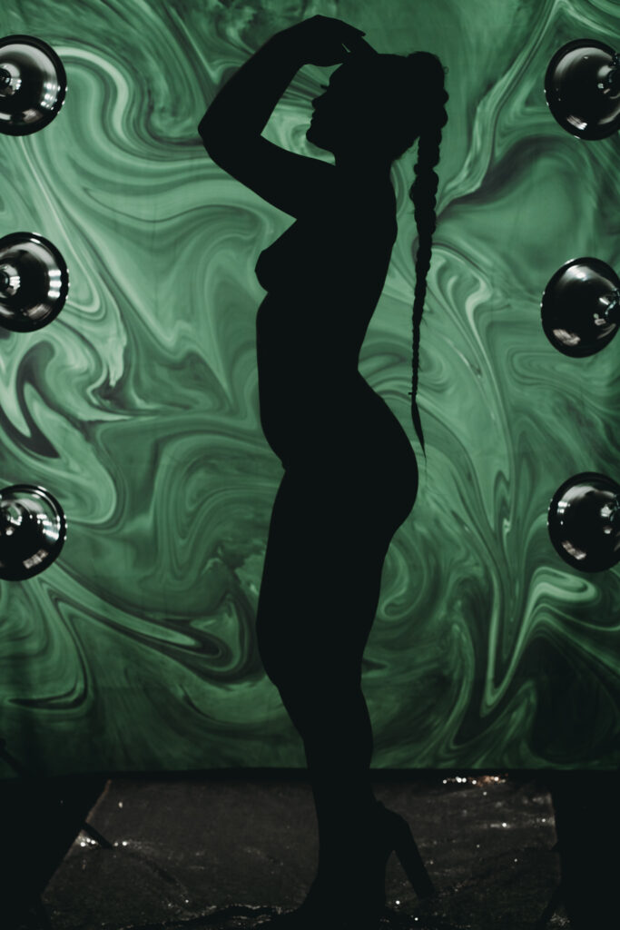 Sexy silhouette of a woman in front of a green back ground. Photo by Embodied Art Boudoir. Golden, great location, savings, Colorado, female photographer, unique, savings, female photographer, boudoir photos