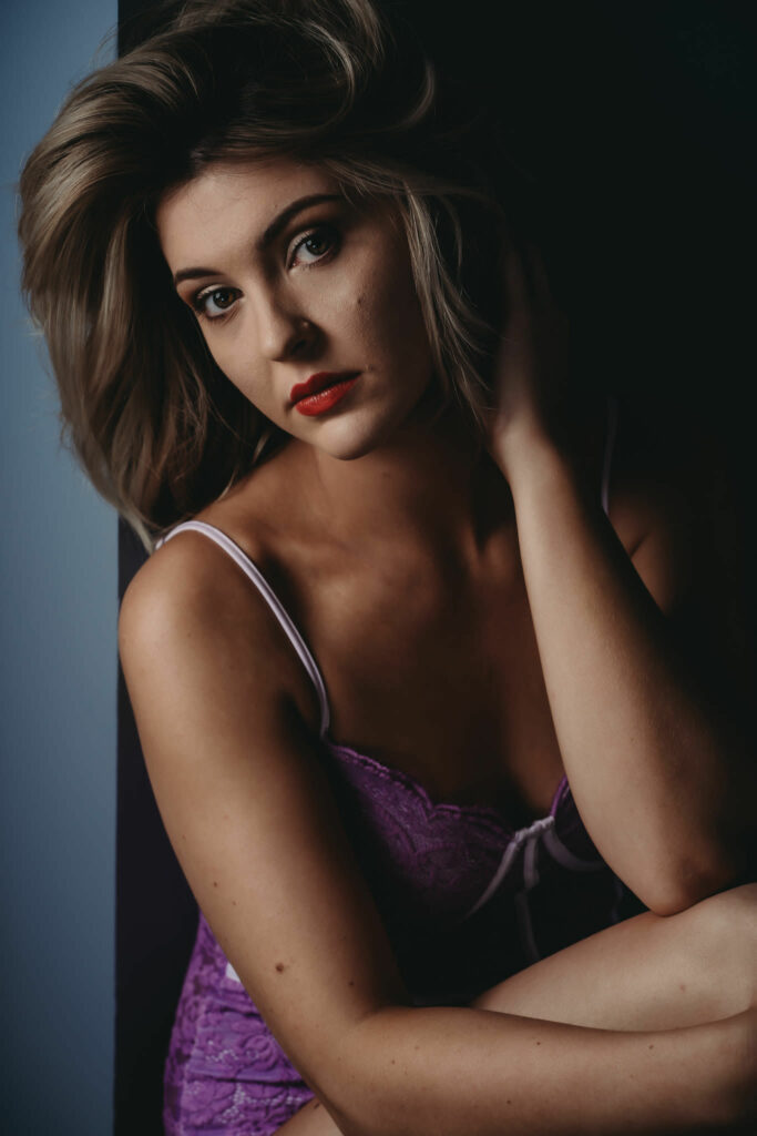 Blonde woman looking sweetly into camera wearing a purple bodysuit. Photo by Embodied Art Boudoir. Books to read, personal growth, personal transformation, self care, support, novels, great reads, feminine photography, colorado boudoir, denver boudoir, boulder boudoir, colorado springs boudoir, boudoir ideas, boudoir poses, boudoir inspiration, photography inspiration, boudoir session, boudoir photos