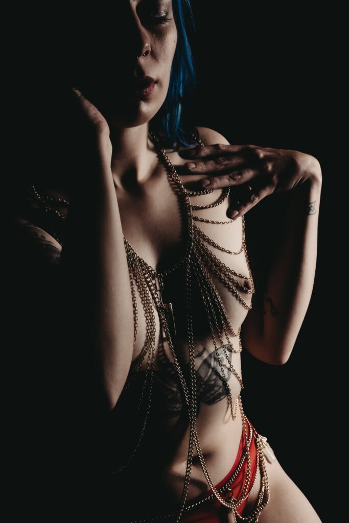 Woman wearing body chains and red panties and nothing else. Photo by Embodied Art Boudoir. Embrace sensuality, sensual, wellness, connection, embodied, desires, five senses, connected, imperfectly perfect, body journey, body love, colorado boudoir, denver boudoir, boulder boudoir, colorado springs boudoir, boudoir ideas, boudoir poses, boudoir inspiration, photography inspiration