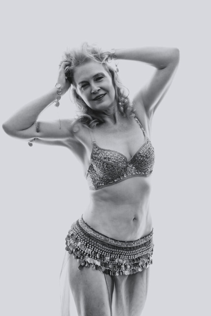 Black and white image of woman wearing a bra and skirt. Photo by Embodied Art Boudoir. Celebrate, journey, growth, self-acceptance, self-love, body neutrality, embodiment, confidence boost, boudoir photography, photoshoot, boudoir, colorado boudoir, denver boudoir, boulder boudoir, colorado springs boudoir