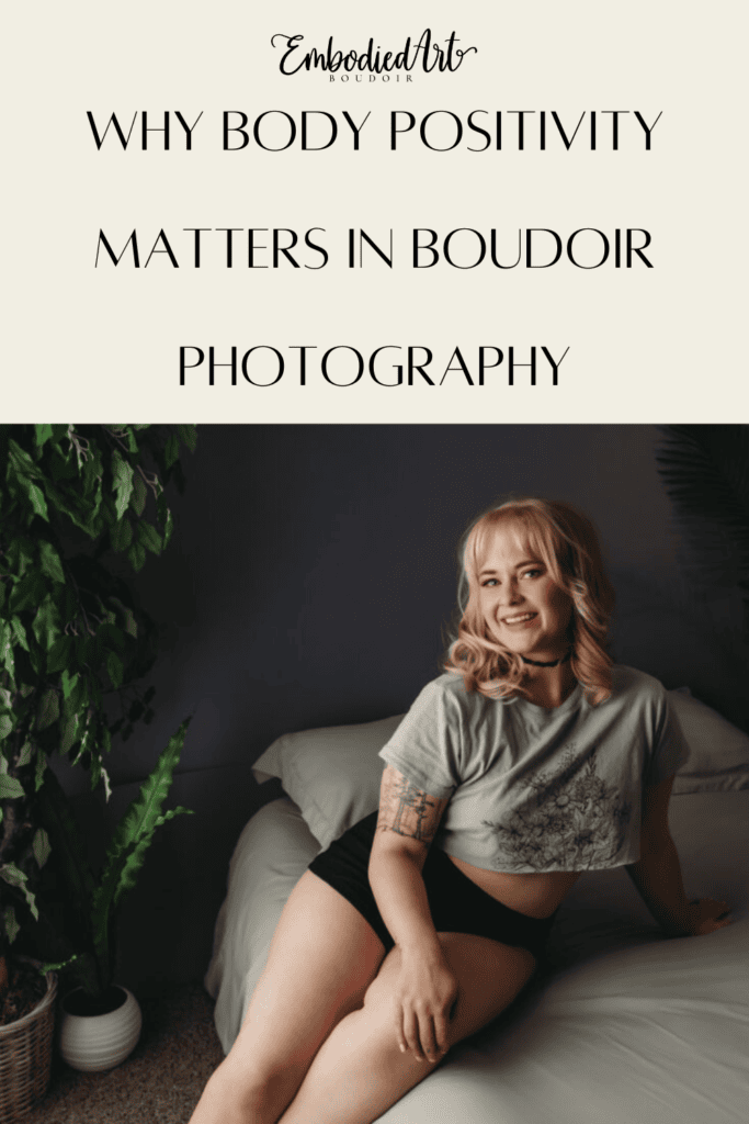Cute smily blond sitting on the bed, wearing a grey top and black booty shorts. Photo by Embodied Art Boudoir. Body positivity, Body positive, love yourself, love your body, body acceptance, growth, self-acceptance, women's beauty, inner beauty, goddess, challenge societal standards, redefine beauty, champion diversity, every body is beautiful, colorado boudoir, denver boudoir, boulder boudoir, colorado springs boudoir, boudoir ideas, boudoir poses, boudoir inspiration, photography inspiration