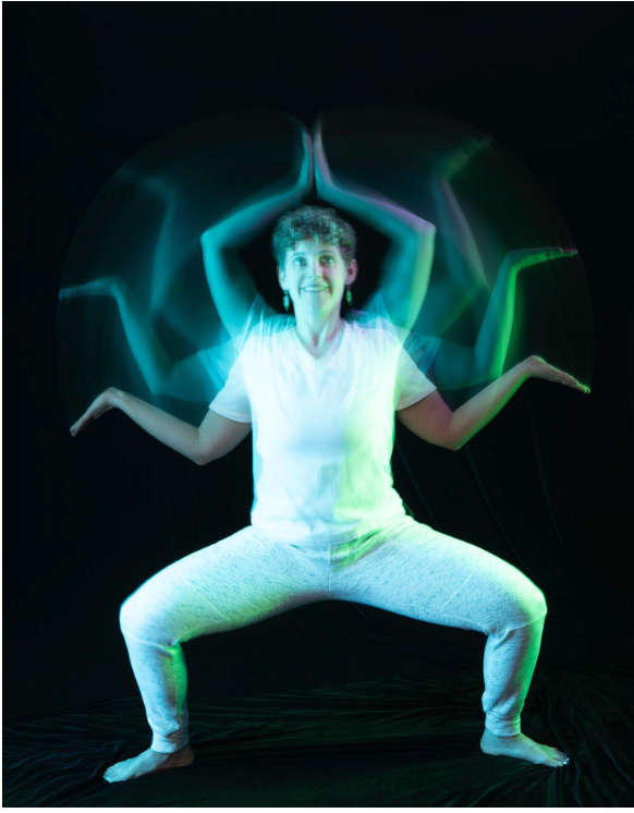 Woman wearing all white posing with strange lights around her with her hands above her head in a prayer pose. Featured in the blog "A Peek Behind the Curtain: The Creative Photoshoots That Feed My Soul." creative photography, creative photoshoot, artistic photography, experimental photography, fine art photography, creative portrait photography, body painting photography, artistic body paint, creative lighting photography, color lighting photography, studio portrait photography, personal photography project, behind the scenes photography, artistic self expression, Colorado photographer. Pic by Embodied Art Boudoir